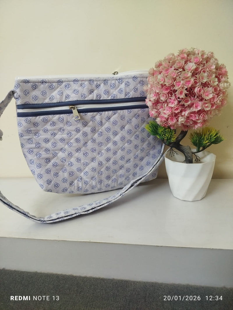 light blue bag with dark blue roses