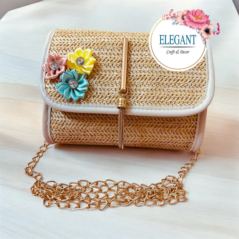 A classy handwoven straw clutch with soft neutral tones, adorned with delicate floral embroidery and a sleek gold clasp—perfect for a chic, minimal yet elegant look.