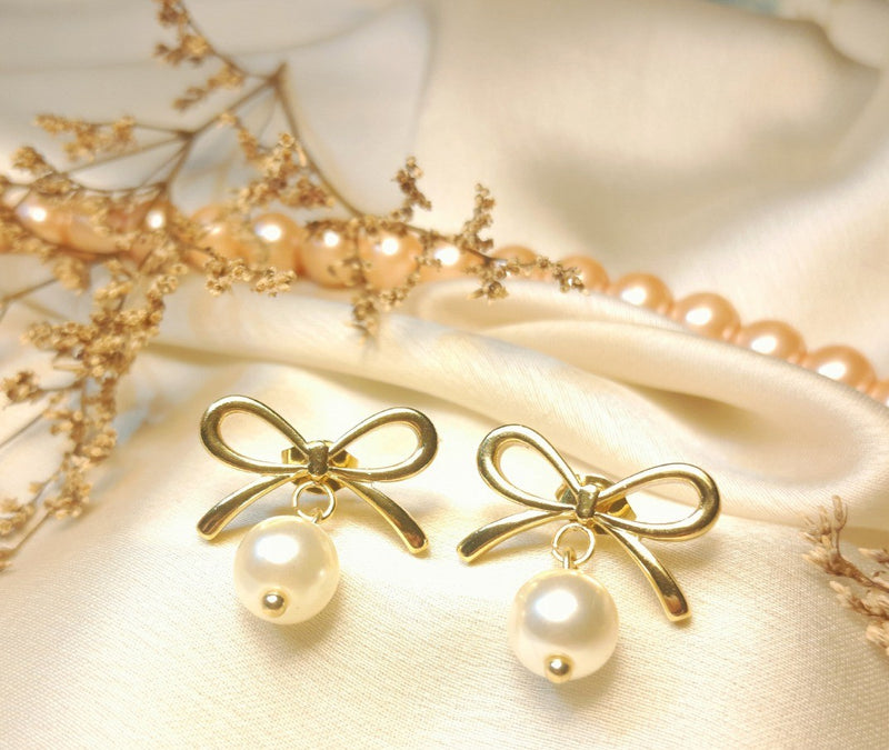 Golden bow tie pearl earrings